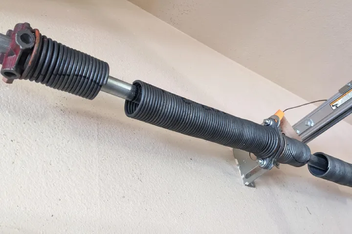 Broken spring repair service for safe garage door balance and smooth lifting