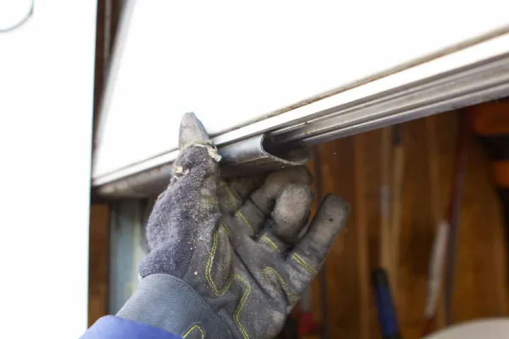 Garage door weather seal replacement to block dust rain pests and drafts